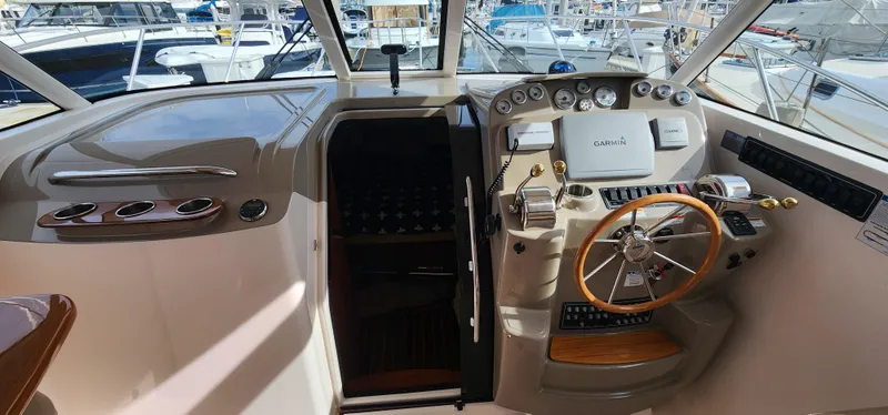 2012 Tiara Yachts 3100 Coronet helm with steering wheel and control panel.