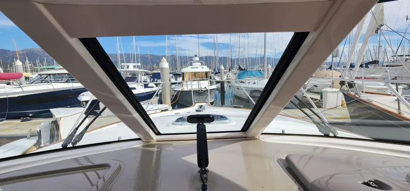 View from 2012 Tiara Yachts 3100 Coronet, overlooking marina with multiple boats docked.