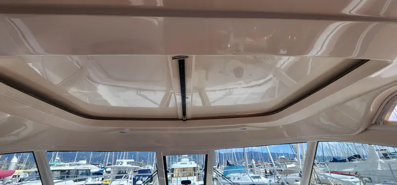 Ceiling view of 2012 Tiara Yachts 3100 Coronet with marina background.