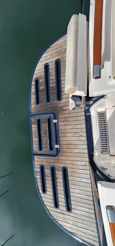 2012 Tiara Yachts 3100 Coronet swim platform with wooden finish and ladder.