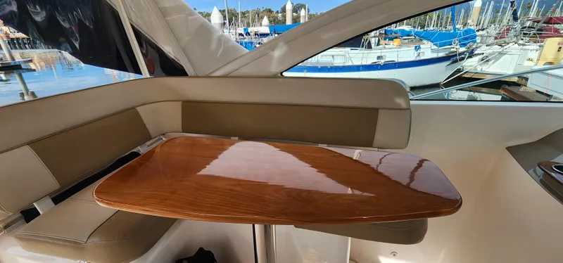 Interior of 2012 Tiara Yachts 3100 Coronet with wooden table and seating.