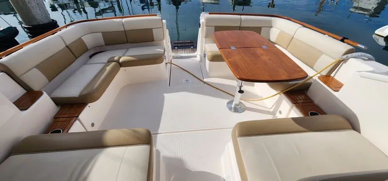 Luxurious 2012 Tiara Yachts 3100 Coronet with spacious seating and elegant wooden table.