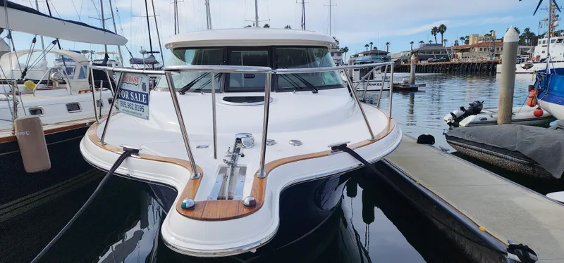 2012 Tiara Yachts 3100 Coronet docked, for sale sign visible, marina background.
