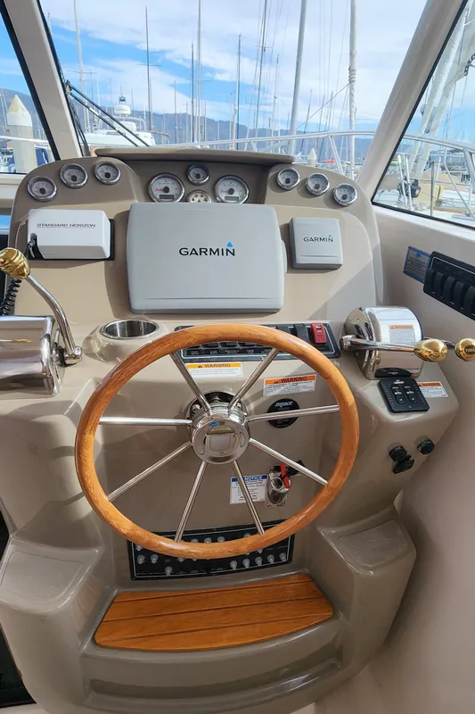 2012 Tiara Yachts 3100 Coronet helm with Garmin navigation and wooden steering wheel.