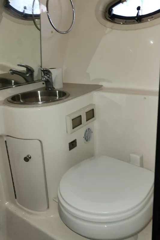 Compact bathroom in 2012 Tiara Yachts 3100 Coronet, featuring sink and toilet.