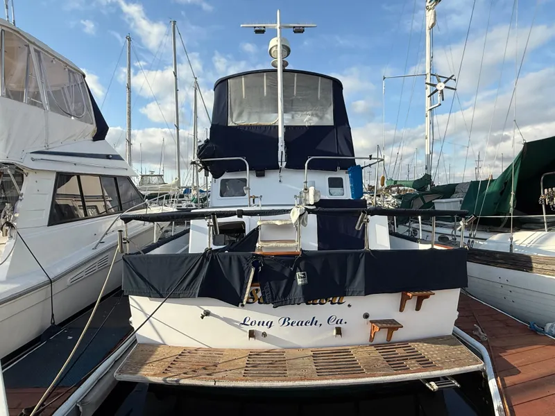 1978 C & L 37 yacht docked in Long Beach marina, surrounded by other boats.