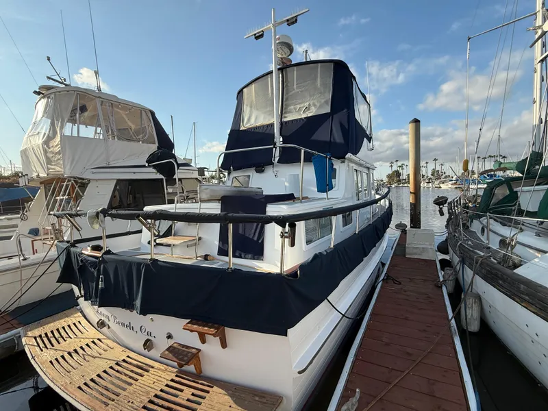 1978 C & L 37 boat docked at marina under clear blue sky.