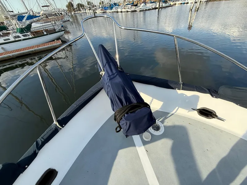 Bow of 1978 C & L 37 boat docked in marina, covered equipment visible.
