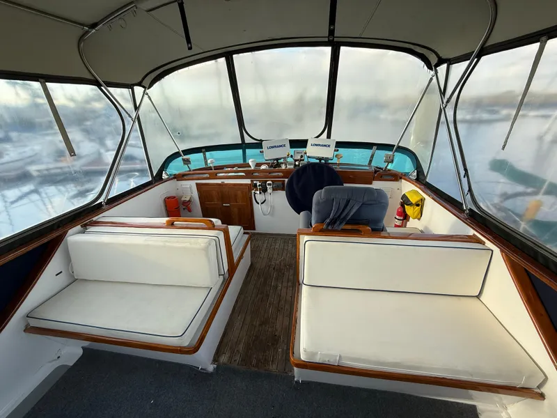 1978 C & L 37 boat interior with white seating and helm station.