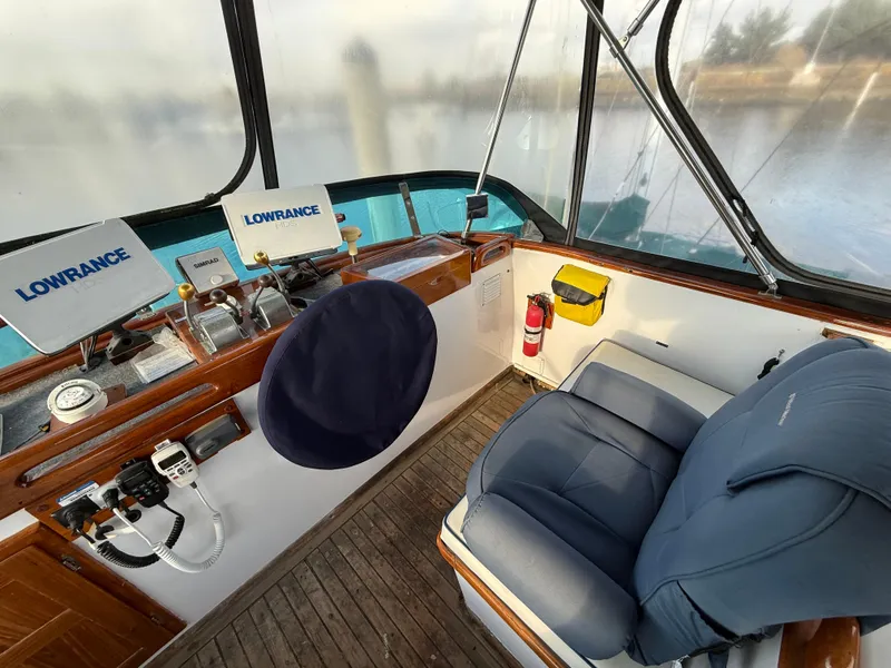 1978 C & L 37 boat cockpit with navigation equipment and blue seating.