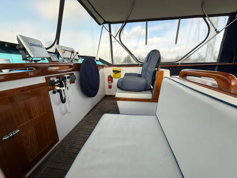Interior of a 1978 C & L 37 boat with seating and navigation equipment.