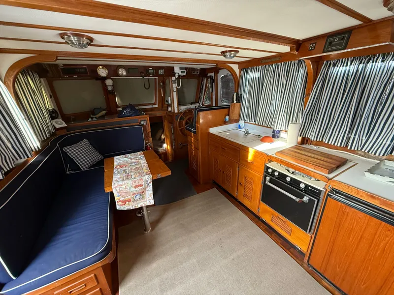 Interior of a 1978 C & L 37 boat with wood paneling and nautical decor.
