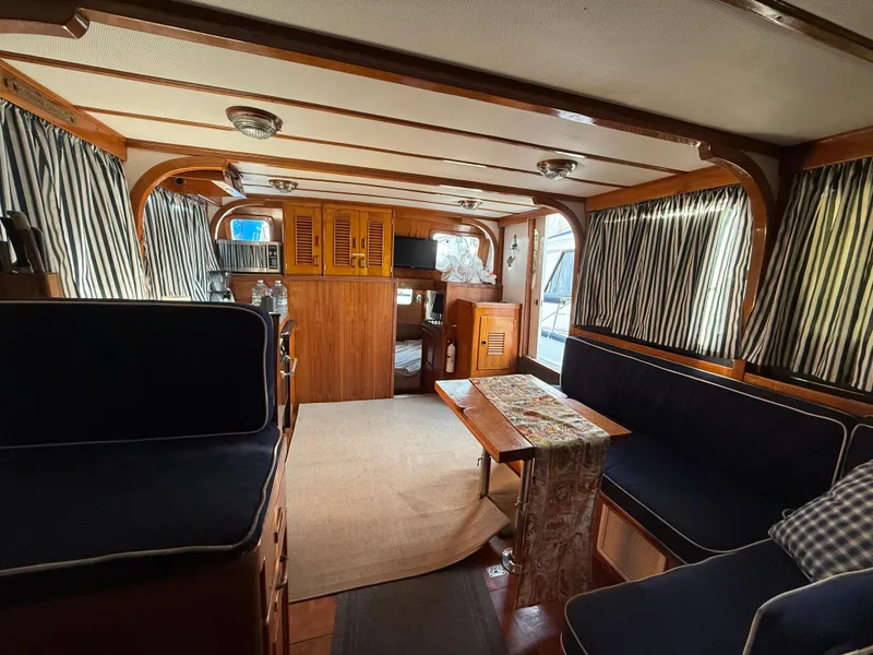 Interior of a 1978 C & L 37 boat with wood paneling and navy seating.