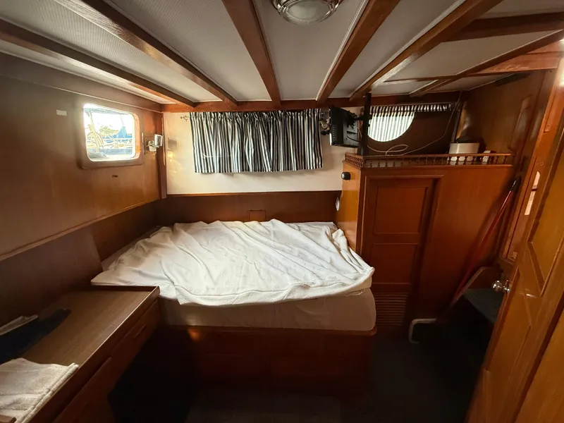 1978 C & L 37 boat cabin with bed, wooden interior, and window.