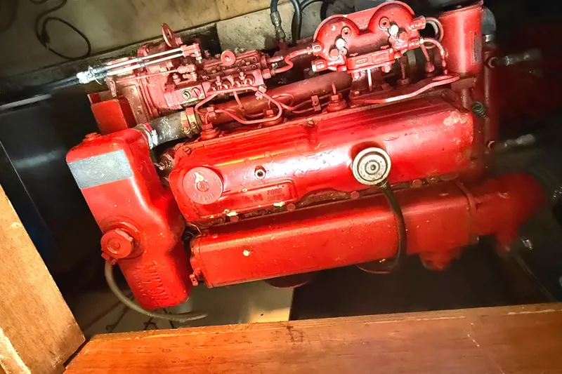 Red engine of a 1978 C & L 37 model, showcasing mechanical components.