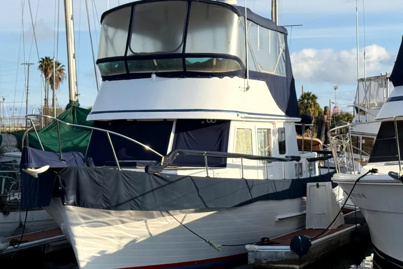 1978 C & L 37 yacht docked at marina, featuring blue and white exterior.
