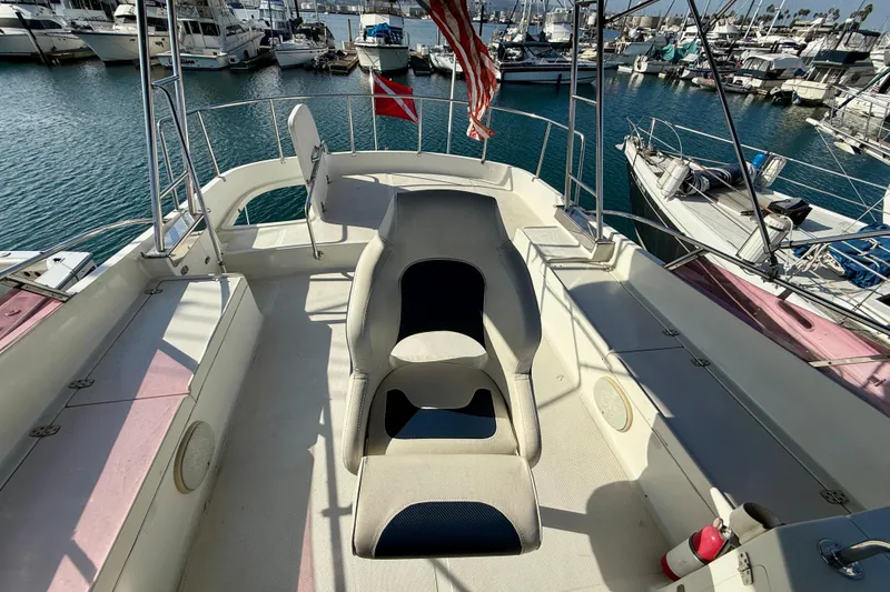 1990 Mikelson 42 yacht deck with seating, docked in a marina.