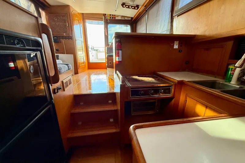 Interior of 1990 Mikelson 42 yacht with kitchen and seating area.