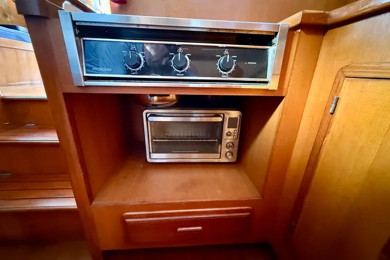 Built-in stove and toaster oven in a 1990 Mikelson 42 yacht kitchen.