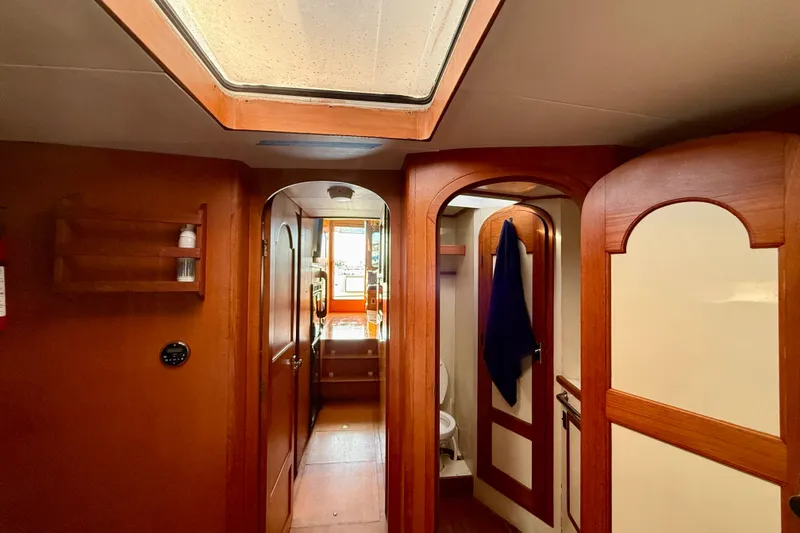 Interior of 1990 Mikelson 42 yacht, featuring wooden doors and skylight.