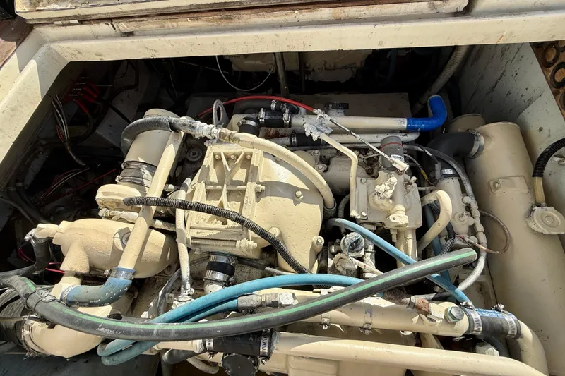 Engine compartment of a 1990 Mikelson 42 boat, showcasing intricate mechanical components.