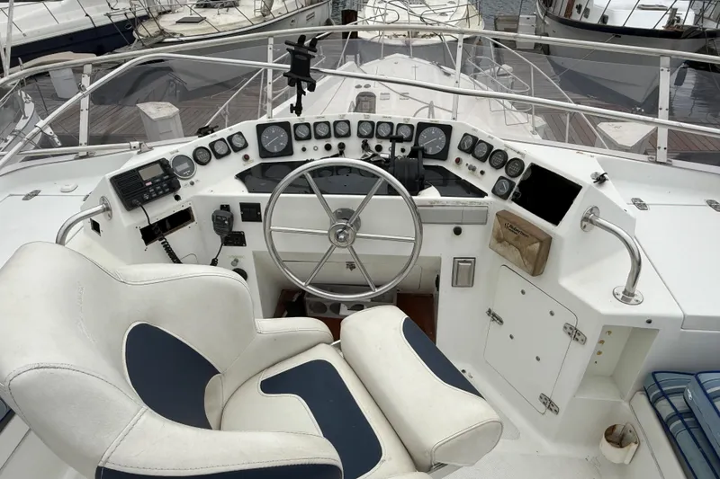 Cockpit of a 1990 Mikelson 42 yacht with steering wheel and control panel.