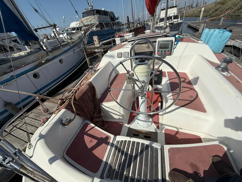 Cockpit of a 1989 Hunter 30 sailboat docked at a marina.