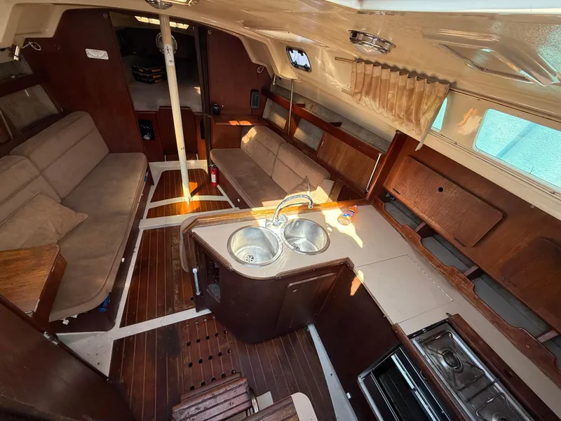 1989 Hunter 30 sailboat interior with wood finish, dual sink, and seating area.