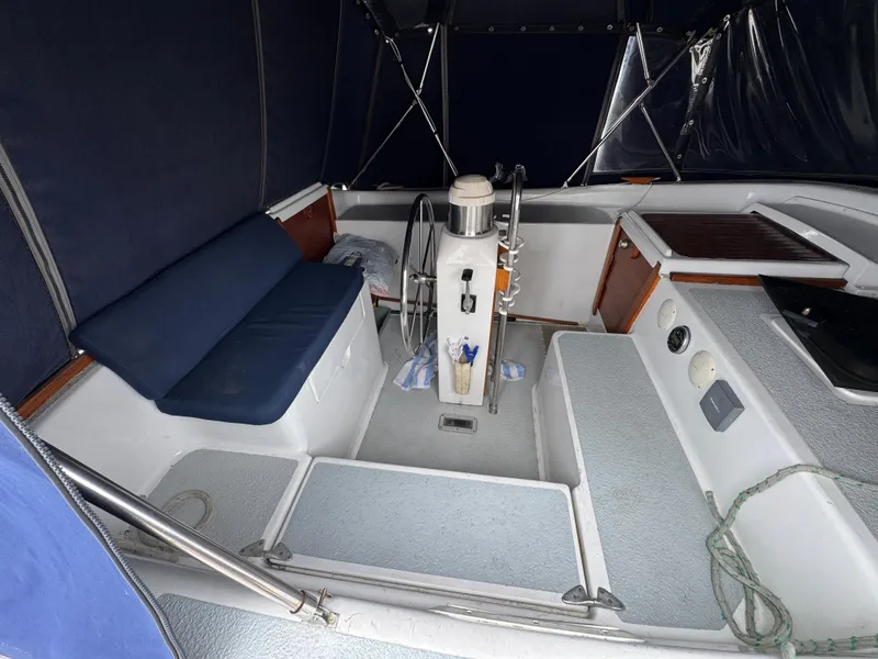 1981 Morgan 416 Out Island sailboat cockpit with steering wheel and seating area.