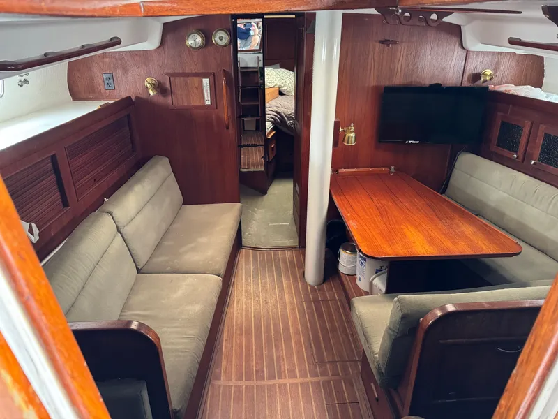 Interior of 1981 Morgan 416 Out Island sailboat with wood paneling and seating area.