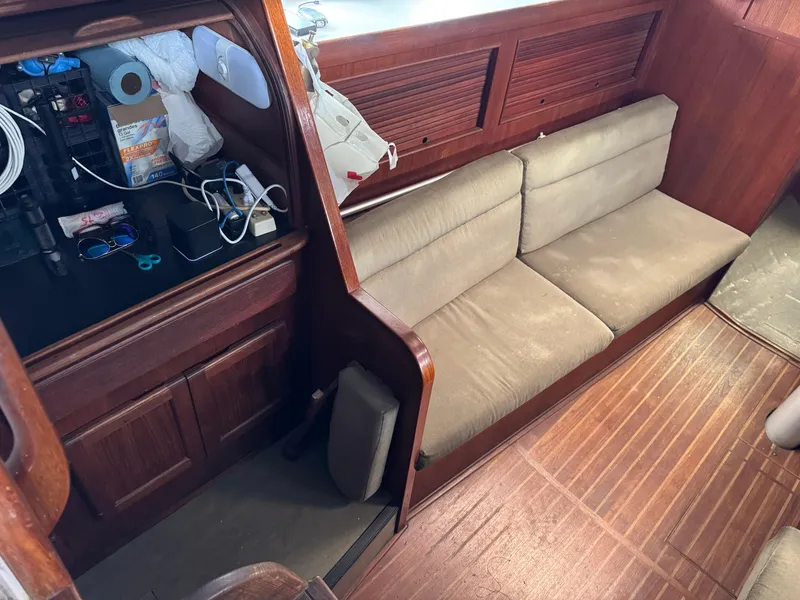 Interior of 1981 Morgan 416 Out Island sailboat with wooden finish and beige seating.