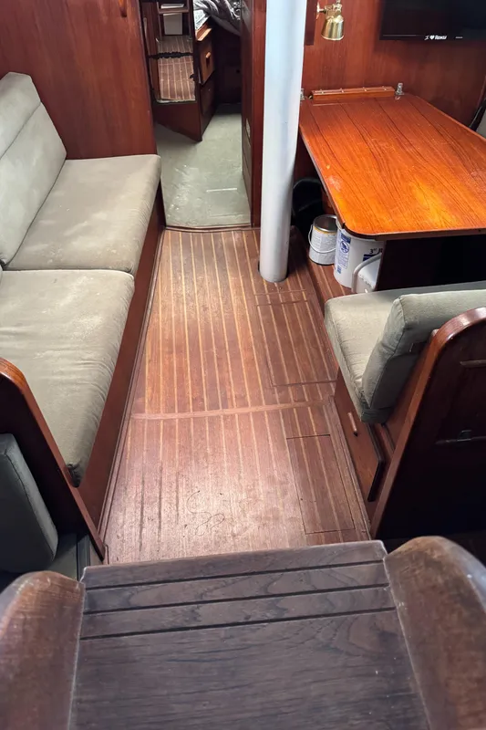 Interior of 1981 Morgan 416 Out Island sailboat with wooden flooring and seating area.