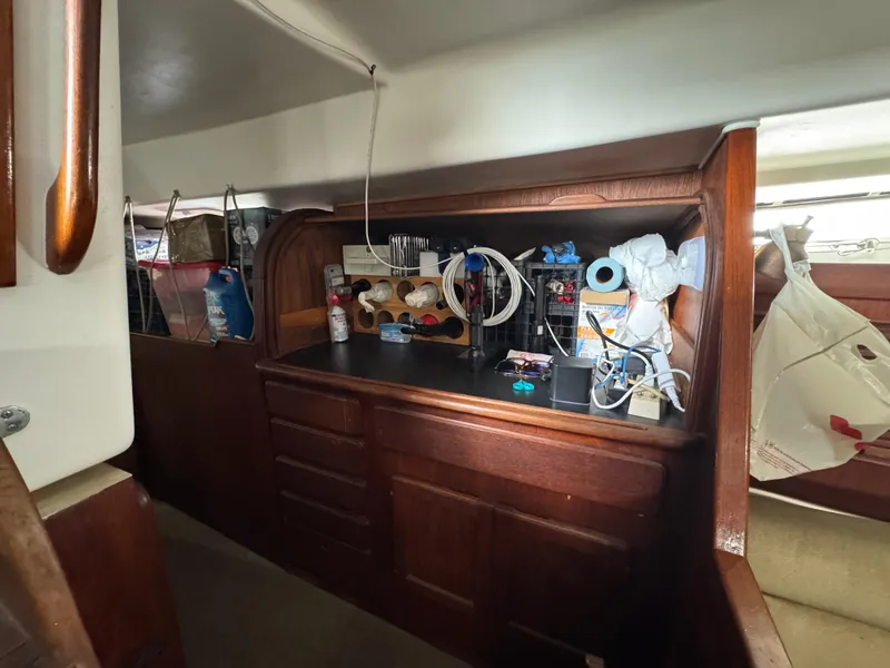 Interior of 1981 Morgan 416 Out Island sailboat with wooden cabinetry and storage.