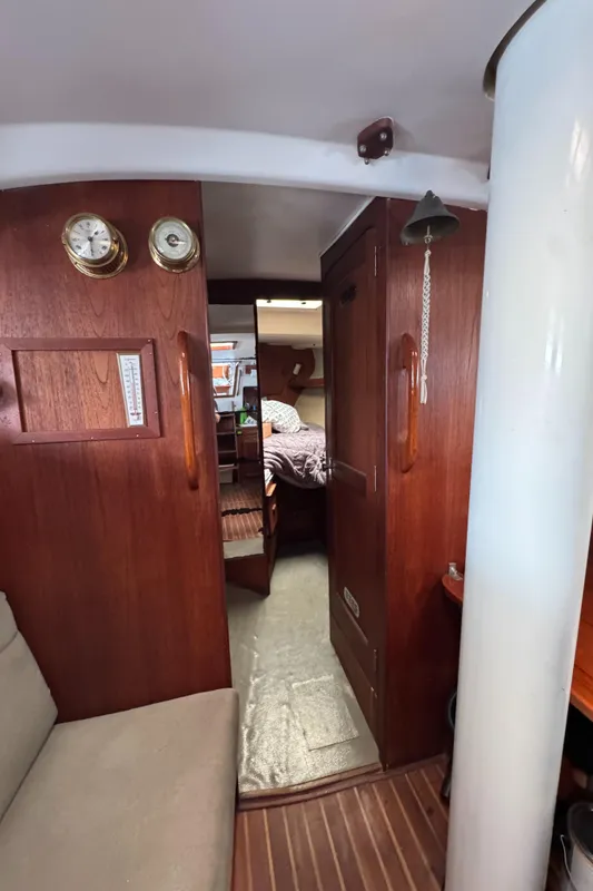 Interior of 1981 Morgan 416 Out Island sailboat with wooden paneling and cozy cabin.