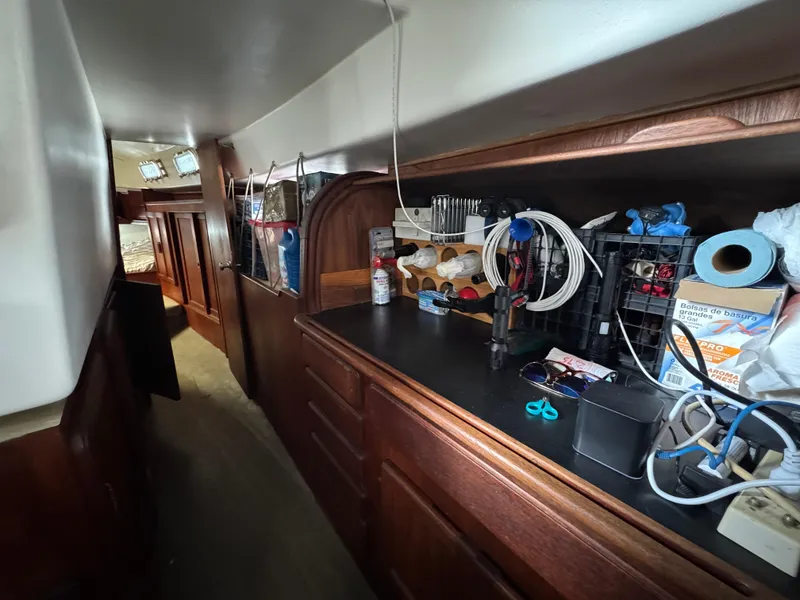 Interior of 1981 Morgan 416 Out Island yacht with organized storage and wooden cabinetry.