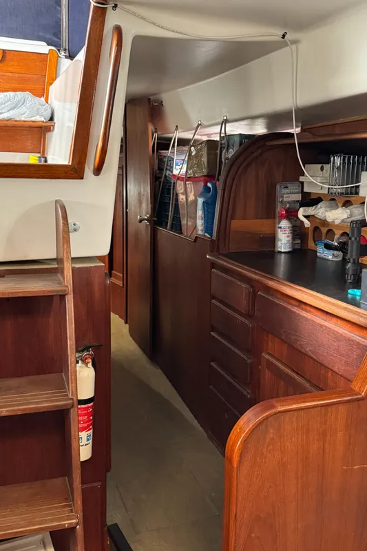 Interior of 1981 Morgan 416 Out Island sailboat with wooden cabinetry and storage.