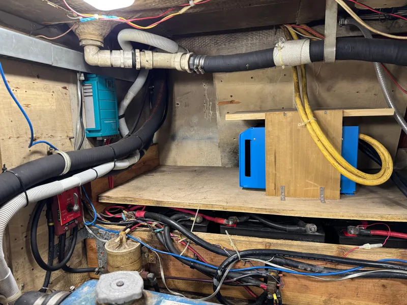 Engine room of 1981 Morgan 416 Out Island sailboat with wiring and equipment.