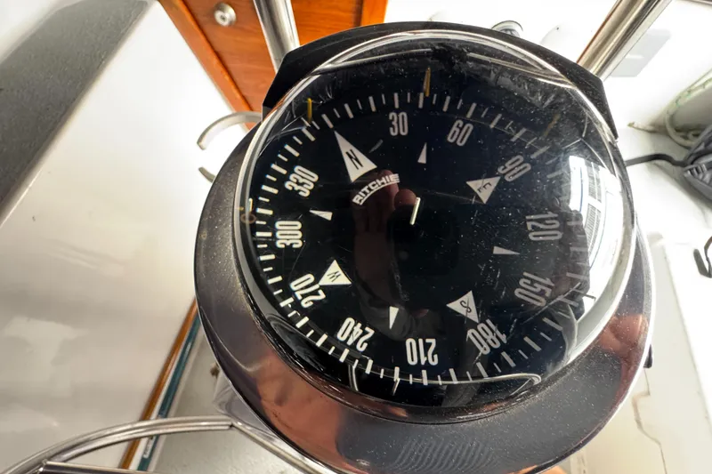 Compass on 1981 Morgan 416 Out Island sailboat, showing navigation directions.