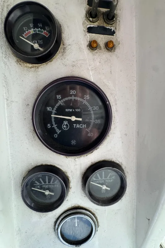 Dashboard gauges of a 1981 Morgan 416 Out Island sailboat, showing tachometer, voltmeter, and more.