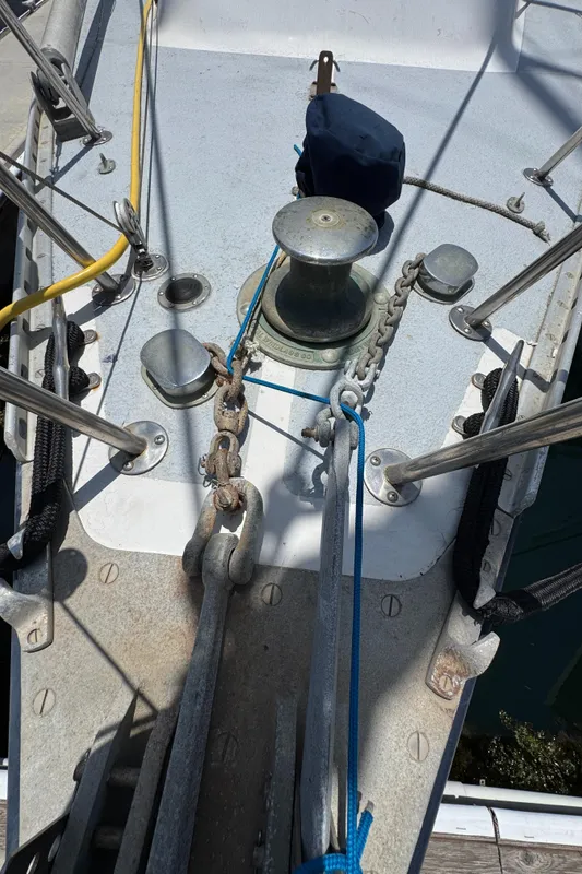 Bow of 1981 Morgan 416 Out Island sailboat with anchor chain and winch.