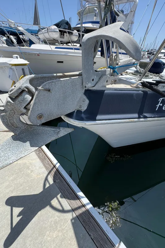 1981 Morgan 416 Out Island sailboat with large anchor at marina dock.