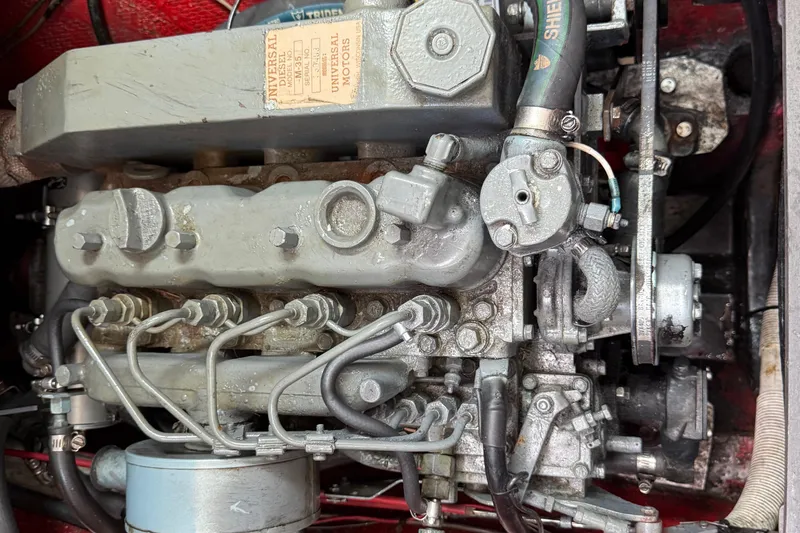 1957 Rhodes Bounty engine close-up, showcasing mechanical components and Universal Motors label.