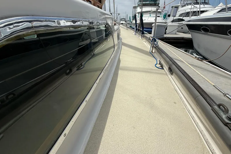 1957 Rhodes Bounty yacht docked at marina, showcasing sleek design and polished exterior.