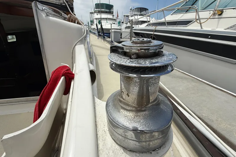 1957 Rhodes Bounty sailboat deck with winch and red cloth.