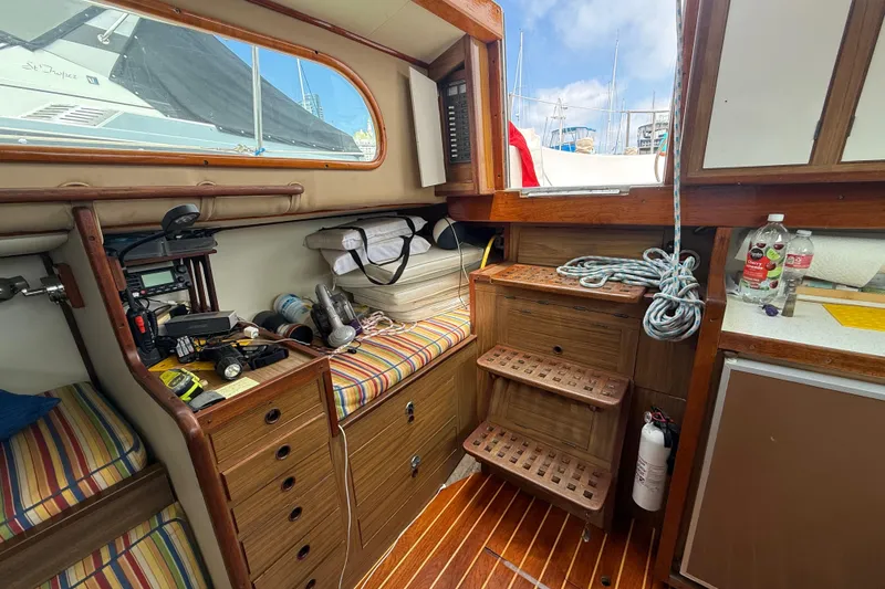 1957 Rhodes Bounty boat interior with wooden cabinetry and nautical equipment.