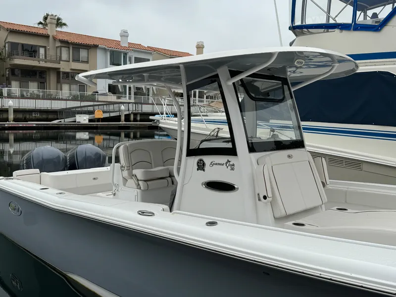 2021 Sea Hunt Gamefish 30 Coffin Box boat docked in a marina.
