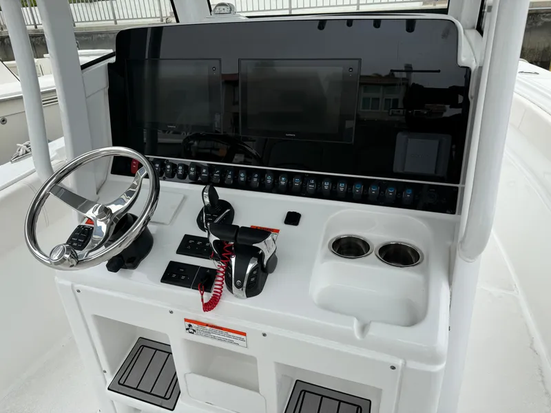 2021 Sea Hunt Gamefish 30 Coffin Box helm with steering wheel and control panel.
