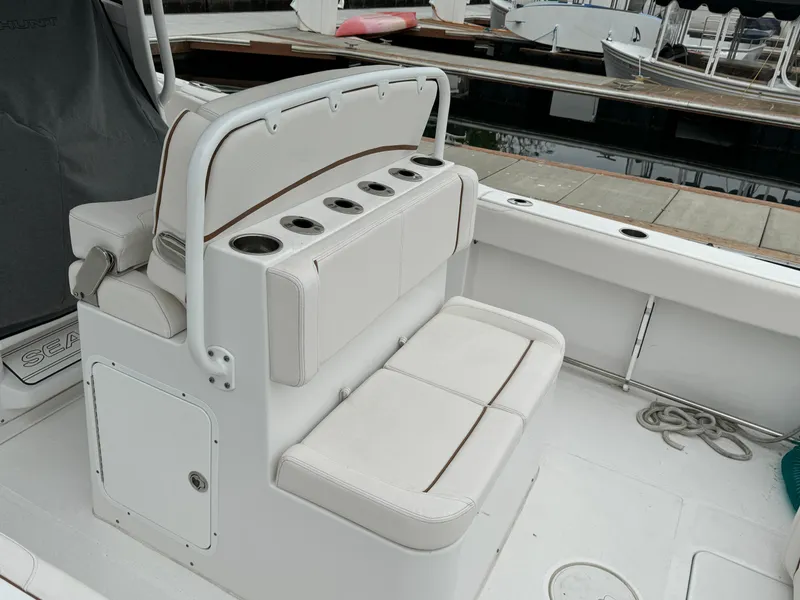 2021 Sea Hunt Gamefish 30 Coffin Box boat seating with cup holders at dock.