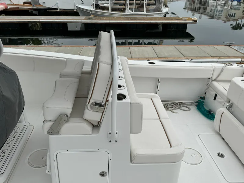 2021 Sea Hunt Gamefish 30 Coffin Box boat interior with white seating and storage.