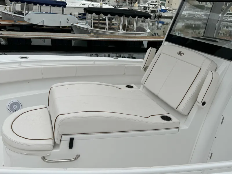 2021 Sea Hunt Gamefish 30 Coffin Box boat interior with white seating at marina.